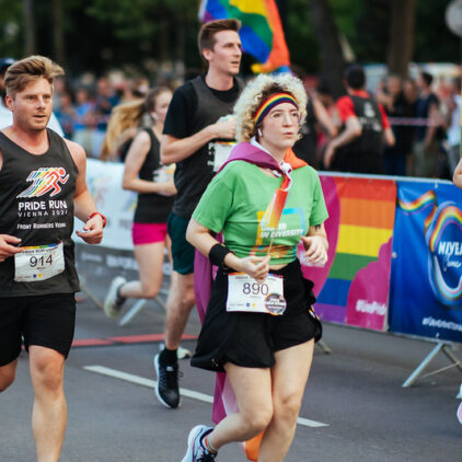 Eine Grüne Läuferin unter anderen Läufer:innen